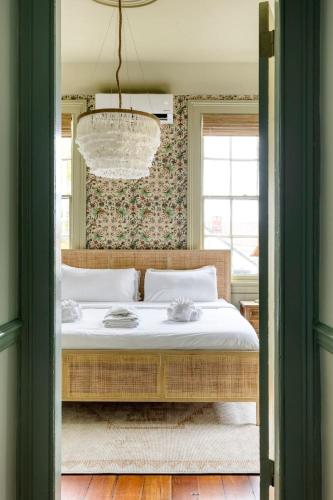 a bedroom with a bed with a chandelier at King Veranda Suite with Breakfast in Charleston