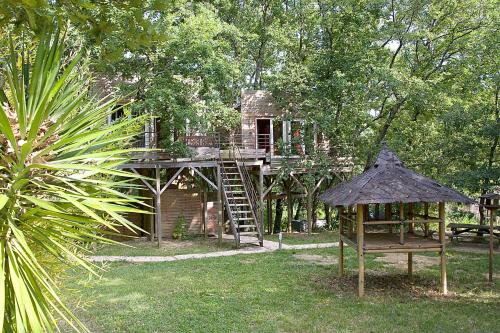 a tree house in the middle of a garden at Natura Lodge in Barjac
