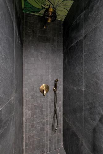 a shower with a shower head in a bathroom at Osada Widokowa Kościelisko in Kościelisko