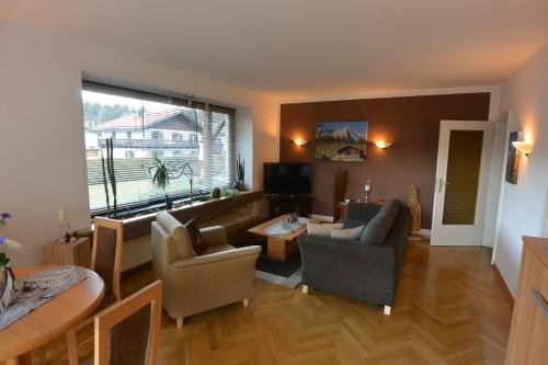 a living room with a couch and a table at Haus Erli in Mittenwald