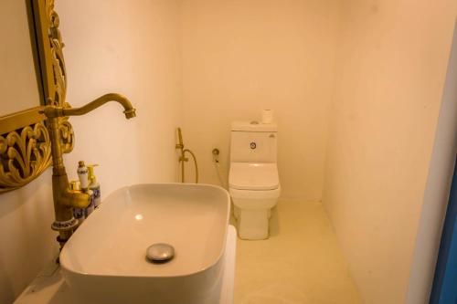 a small bathroom with a toilet and a sink at The Tranquilite' in Anuradhapura