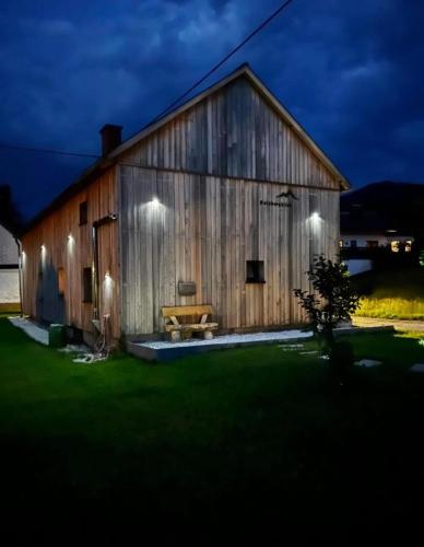 a barn with lights on the side of it at night at Gaisbergblick in Molln