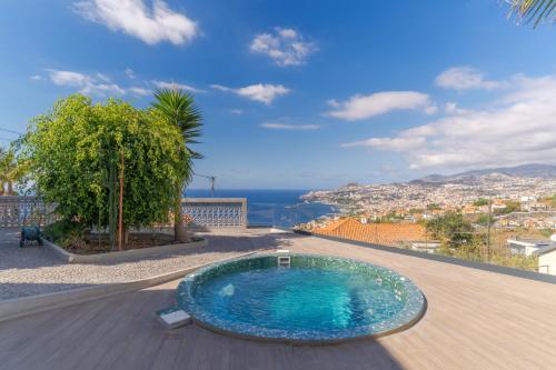 a swimming pool on a balcony with a view of the ocean at Casa Trollis by Holiday Rental Madeira in Funchal