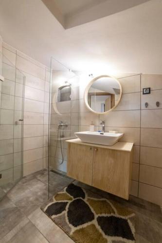 a bathroom with a sink and a mirror at Fine House in Tríkala
