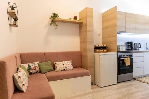 a living room with a couch and a kitchen at Fine House in Tríkala