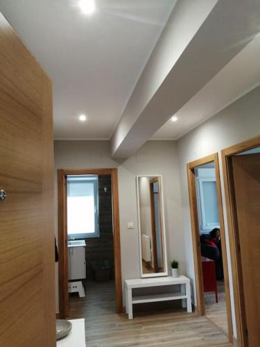 a room with a bathroom with a sink and a mirror at Apartamento Salgueiro ORTIGUEIRA in Santa Marta de Ortigueira