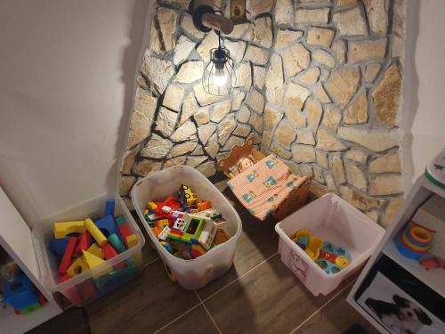 a room with toys on the floor next to a stone wall at Vířivka a sauna na pokoji,nebo na vlastní terase - Farma u Příbrami in Příbram