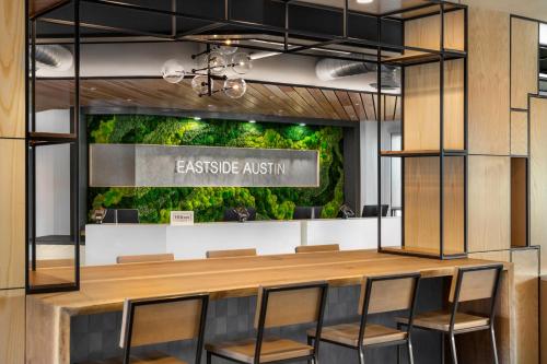 an office lobby with a green wall at Hampton by Hilton East Austin - near UT and Capitol in Austin