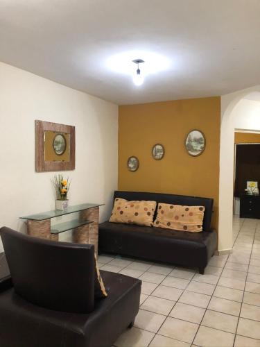 a living room with a couch and a table at Casa Jhon in Tepic