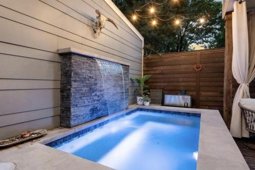 a swimming pool in the backyard of a house at Downtown Private Oasis Stay Fire Pit & Hot Tub in Houston