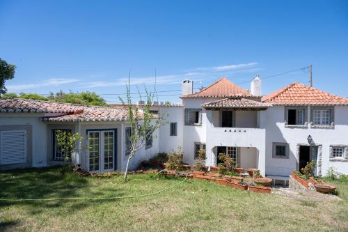 a large white house with a yard at New Family Country House in Colares