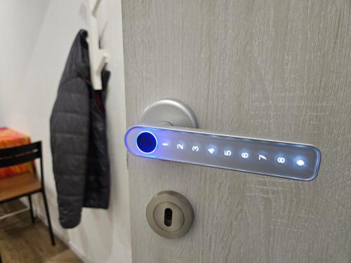 a door with a blue lock on a door with a jacket at Be easy In Selva in Locarno
