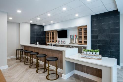 a bar in a dental office with stools at Staybridge Suites Atlanta Airport in Atlanta