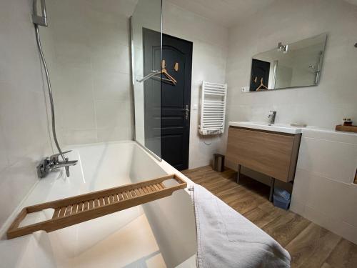 une salle de bain avec une baignoire et un lavabo dans l'établissement Le Jardin du Dan, à Mathieu
