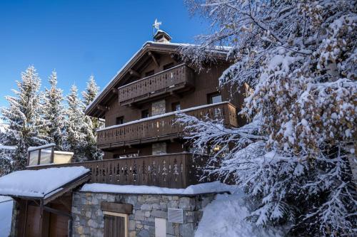 a house covered in snow in the woods at Chalet Matterhorn in Mussillon