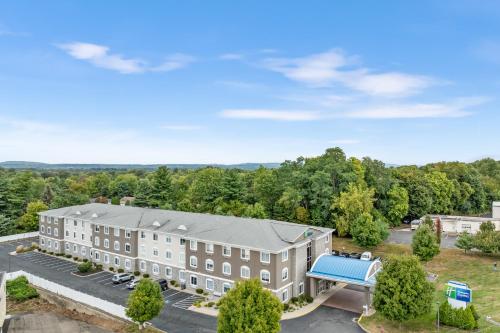 an aerial view of a building with a blue roof at Holiday Inn Express Hartford-Newington by IHG in Newington