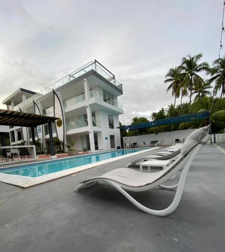 a resort with a pool and lounge chairs next to a building at The Views Resort in El Zonte