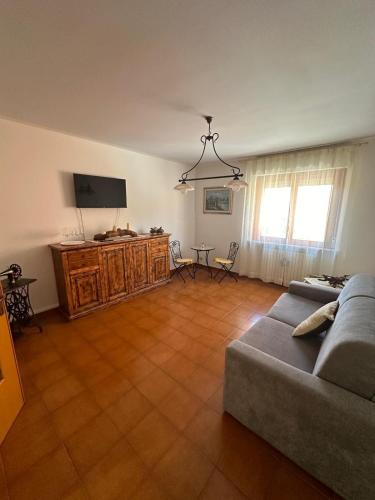 a living room with a couch and a flat screen tv at Casa Vacanze Diva in Rosignano Solvay