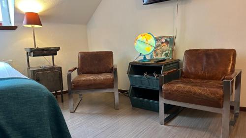 a room with two chairs and a desk and a bed at BE41 Boutique Hotel in Maastricht