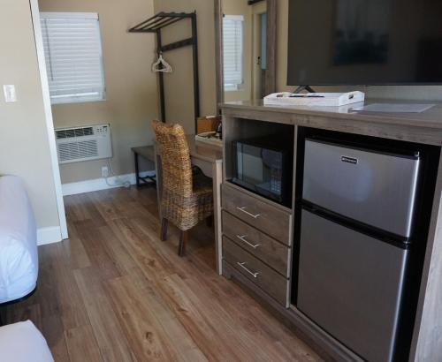 a kitchen with a counter and a desk with a microwave at Bleu Beach Resort in Indialantic