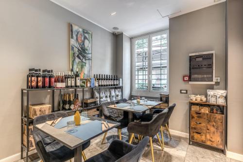 a restaurant with two tables and chairs in a room at Apollo Boutique Hotel in Rome