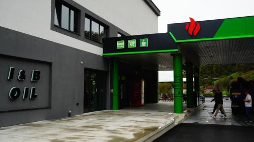 a building with a sign on the side of it at IB Oil doo Restoran s prenoćištem in Cazin