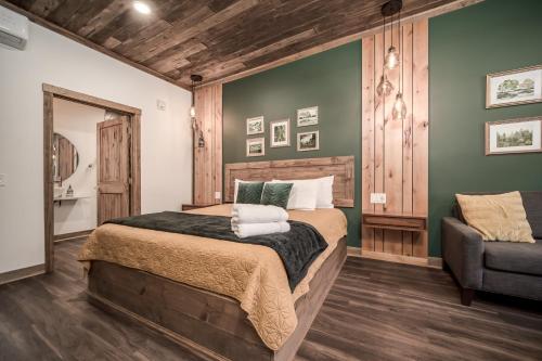 a bedroom with a large bed and a chair at The Port of Prescott Boutique Hotel in Prescott