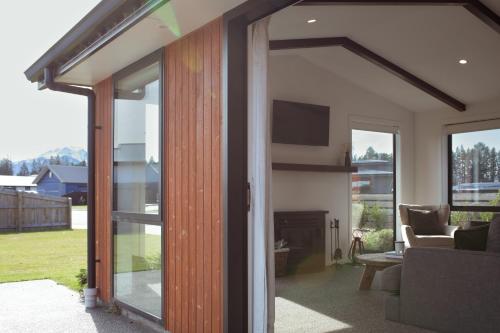 a living room with a sliding glass door and a tv at Gleniffer Views in Methven