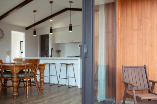 a kitchen and dining room with a table and chairs at Gleniffer Views in Methven