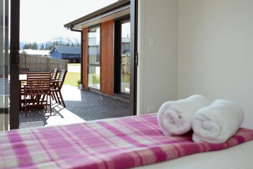 a bed with white towels sitting on top of it at Gleniffer Views in Methven