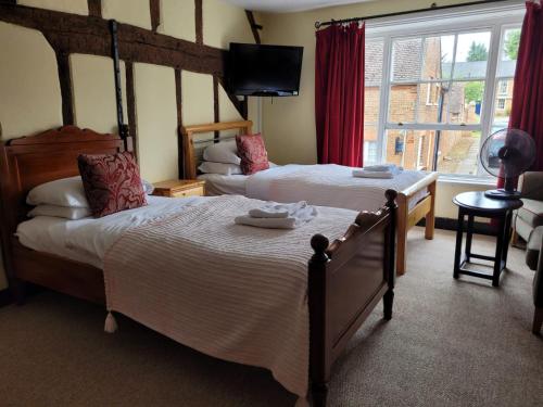 a hotel room with two beds and a window at Longs Hotel & Inn in Woburn