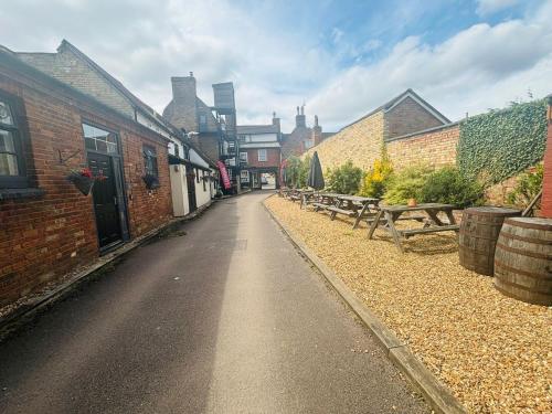 an empty street with benches and buildings on it at Longs Hotel & Inn in Woburn