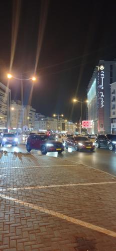 a busy city street at night with cars at Muscat Galaxy Hostel in Muscat