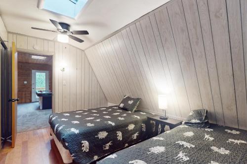 a bedroom with two beds and a ceiling fan at 50 South View Trail in Jasper
