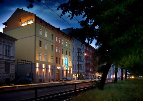 a large building with a clock on the side of it at Melarose Feng Shui Hotel in Berlin