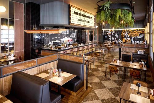 a restaurant with tables and chairs and a bar at Riu Palace Bavaro - All Inclusive in Punta Cana