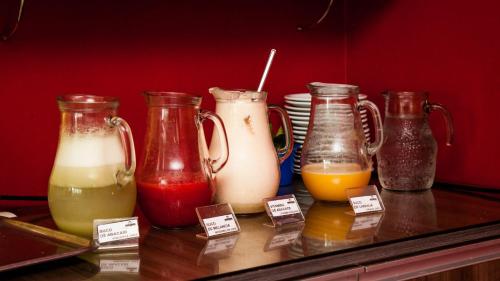 a group of different types of milkshakes on a counter at Nobile Plaza Hotel in Taguatinga