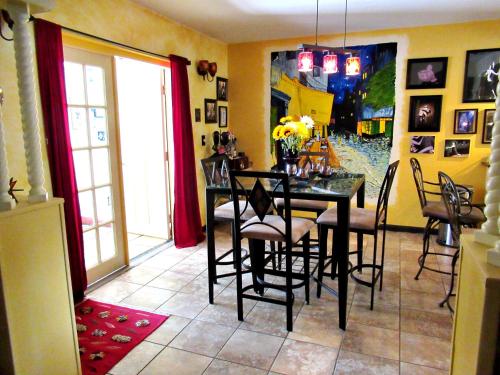 a dining room with a black table and chairs at Eric and Nancy's Boutique Bed and Breakfast in Tampa