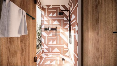 a bathroom with a wall with a patterned wall at Primario Hotel Boutique in Ensenada