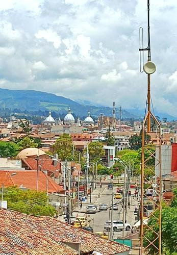 a view of a city with a street and buildings at Dpto. San Andrés, la mejor vista y ubicación in Cuenca