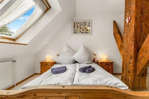 a bedroom with a bed with two pillows on it at Ferienwohnung Nordlicht in Greetsiel