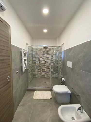 a bathroom with a shower and a toilet and a sink at GuestHouse Affittacamere Padre Pio MORCONE CENTRO in Morcone