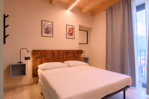 a bedroom with a bed and a large window at Casale Bellavista 1853, Cremia, Lago di Como in Cremia