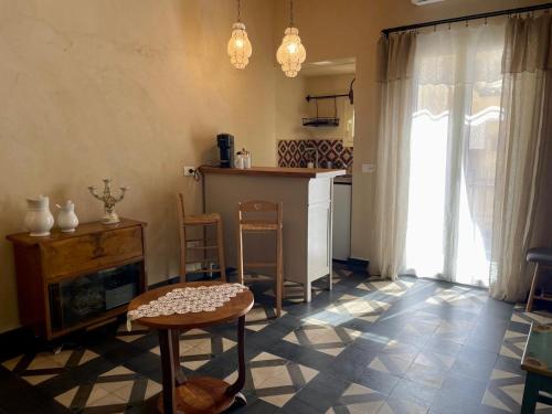 a kitchen with a table and chairs in a room at Maison Yolo - Slow Living Sicily in Agrigento