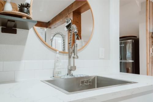 a sink in a kitchen with a mirror at Southtown Stylin' Corvallis OSU PNW in Corvallis