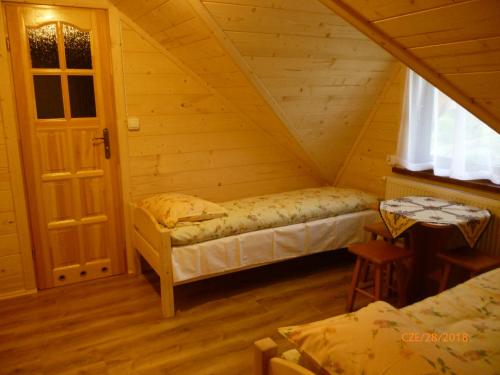 a room with two beds in a attic at Kinga Kulak Pokoje Gościnne in Male Ciche