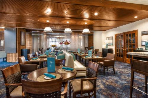 a large dining room with tables and chairs at Radisson Hotel Corning in Corning