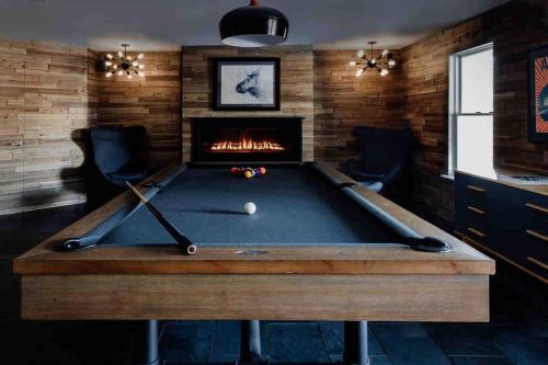 a pool table in a room with a fireplace at Pond Hill Place in Wallingford