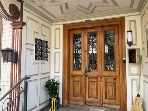 a wooden door with glass windows on a building at 06 - Gästehaus Erika - Hundwil - Appenzellerland in Hundwil