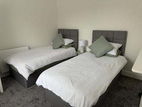 two beds sitting next to each other in a room at 31a locking road in Weston-super-Mare
